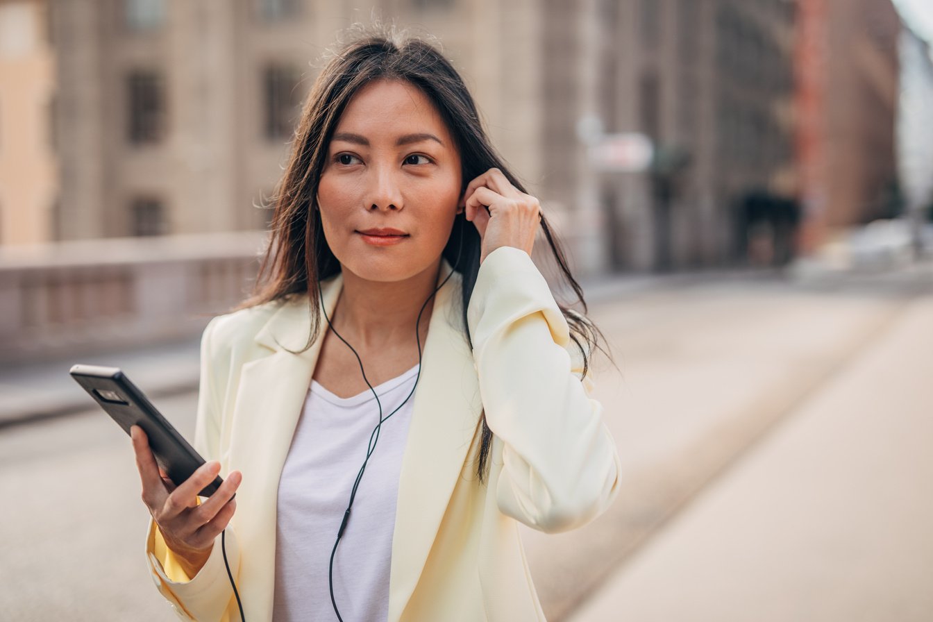 Businesswoman listening to headphones